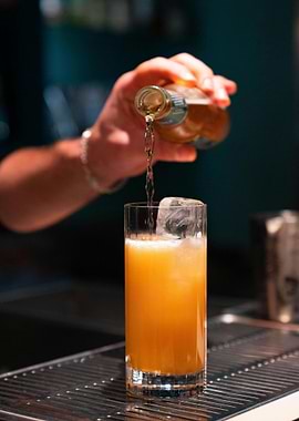 Pouring a cocktail into a glass