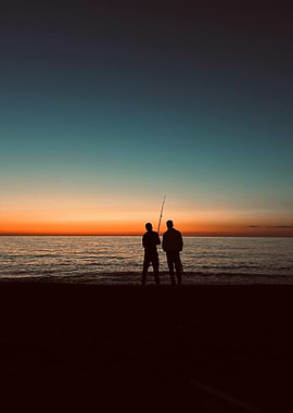 Silhouette of fishermen at sunset