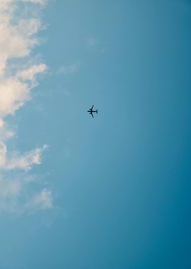 Airplane in Blue Sky with Clouds