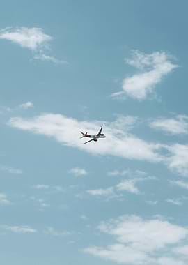 Airplane in a Cloudy Blue Sky