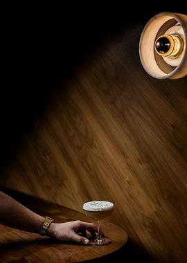 Cocktail on Wooden Table with Hand