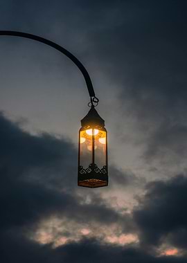 Illuminated Lantern Against Cloudy Sky