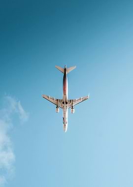 Airplane in flight against blue sky