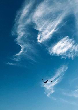 Airplane with two fighter jets in sky