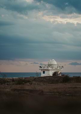 Coastal Observatory Under Cloudy Sky