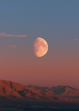 Moon over mountains at dusk