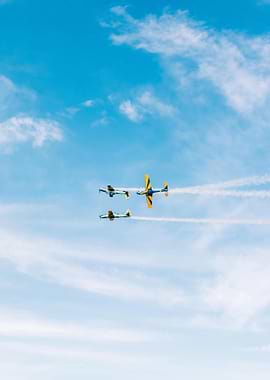 Planes in formation against blue sky