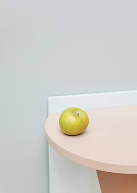 Green apple on a pink table