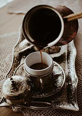 Pouring Turkish Coffee into ornate cup