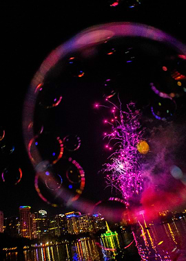 Bubbles and Fireworks over Cityscape at Night