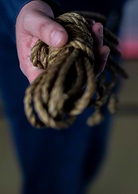Hand Holding Brown Rope