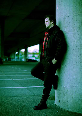 Man Leaning Against Concrete Pillar