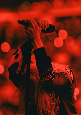 Singer performing on stage in red light