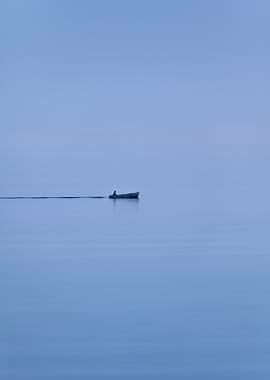 Lone boat on calm blue water