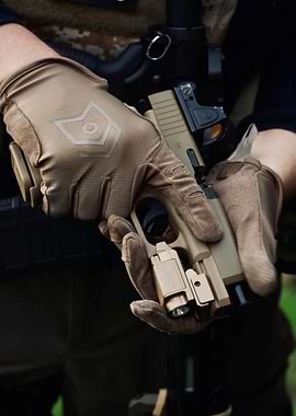 Tan Pistol Held in Gloved Hands