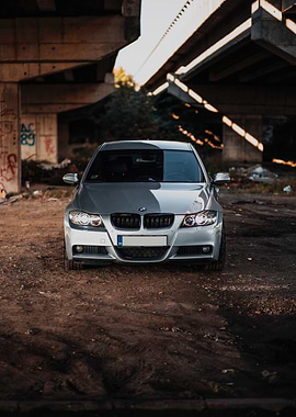 Silver BMW under a bridge