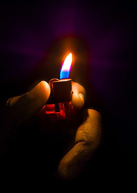 Hand holding a lit lighter