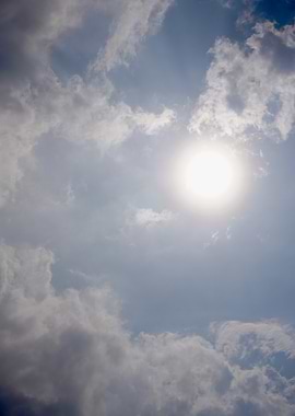 Sun and Clouds in Blue Sky