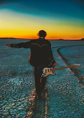 Guitarist walking in the desert at sunset