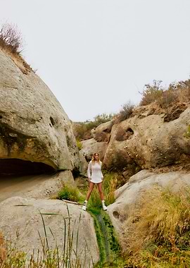 Woman in White Dress, Rocky Landscape