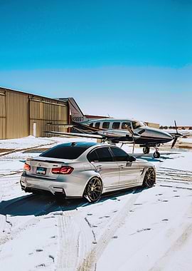 Silver BMW M3 with Airplane Backdrop