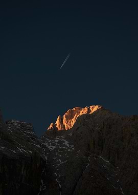 Mountain Peak and Airplane Contrail