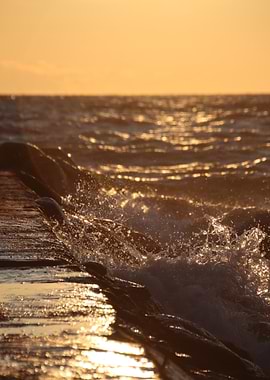 Golden Waves Crashing on Pier