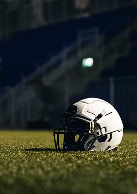 Football Helmet on Field at Night