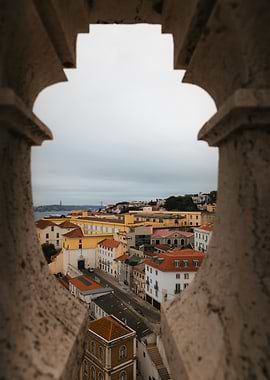 Lisbon cityscape through stone window frame
