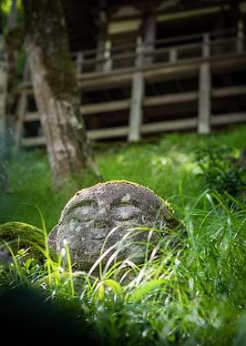 Stone Jizo Statue in Green Grass