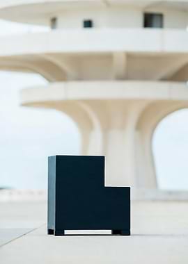Black Block Sculpture with Building Backdrop