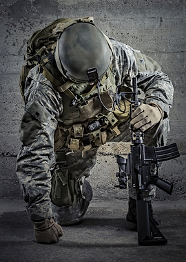 Soldier kneeling with rifle in hand