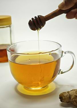 Honey being poured into a cup