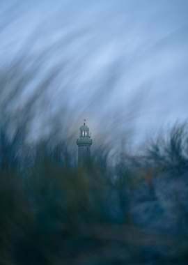 Lighthouse through the grass