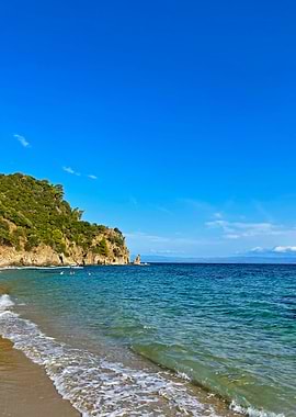 Beach with Cliff and Blue Sky