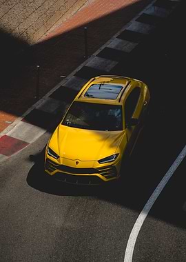 Yellow Lamborghini Urus on monaco's fairmont hairpin