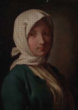 A girl in a blue jacket and white headscarf