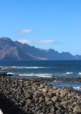 Rocky Beach with Distant Mountains