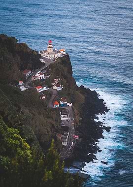 Lighthouse on Cliffside with Coastal Village