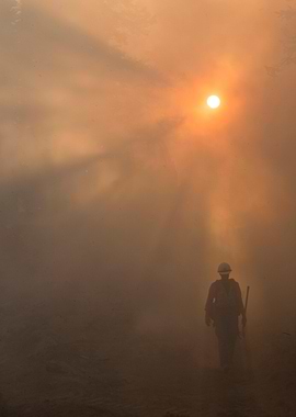 Firefighter in Smoke at Sunset