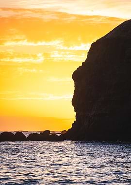 Coastal Sunset with Cliff Silhouette