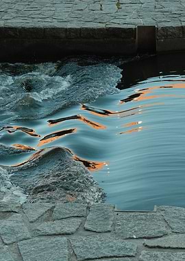 Water flowing over stone embankment