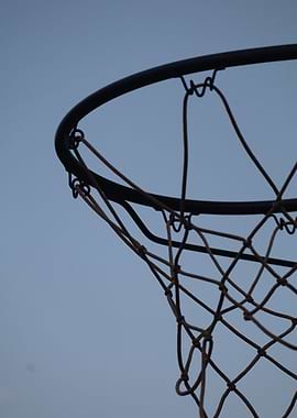 Basketball hoop against a blue sky