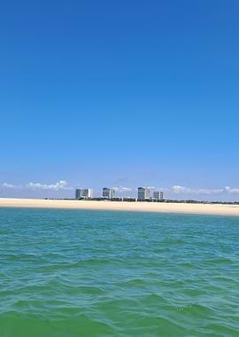 Beachfront buildings under a clear sky