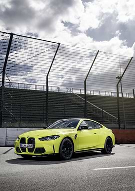 Yellow BMW M4 on Racetrack