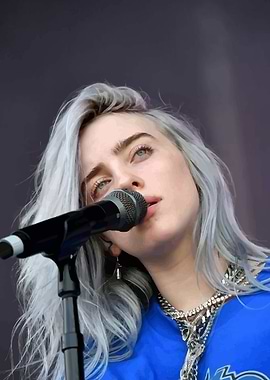 Billie Eilish singing into microphone