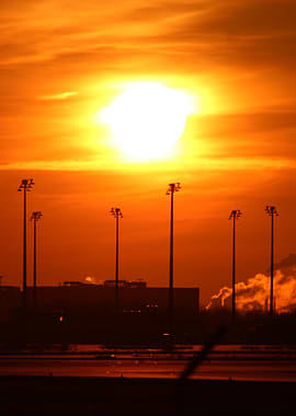 Fiery Sunset Over Industrial Landscape