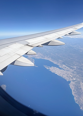 Airplane Wing Over Coastline