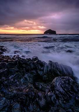Dramatic Coastal Sunset with Rocky Shore