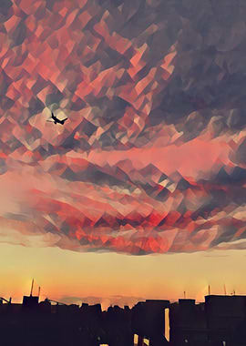 Airplane flying over city at sunset